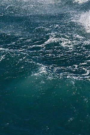 Big wave surfer Maya Gabeira of Brazil rides a wave during a tow surfing session at Praia do Norte on February 24, 2021 in Nazare, Portugal. Photo by Octavio Passos/Getty Images