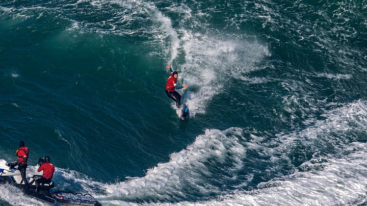 Big wave surfer Maya Gabeira of Brazil rides a wave during a tow surfing session at Praia do Norte on February 24, 2021 in Nazare, Portugal. Photo by Octavio Passos/Getty Images