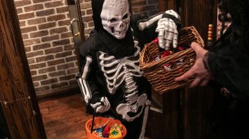 Children go trick-or-treat at a restaurant on Halloween, October 31, 2019 in New York City. Photo by Jeenah Moon/Getty Images