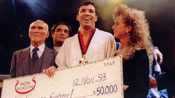 Jiu-Jitsu black belt Royce Gracie (USA) receives a $50,000 check after becoming "The Ultimate Fighter" by defeating Gerard Gordeau of the Netherlands int he finals of the Ultimate Fighter Championships in Denver, Colorado. Photo by Markus Boesch