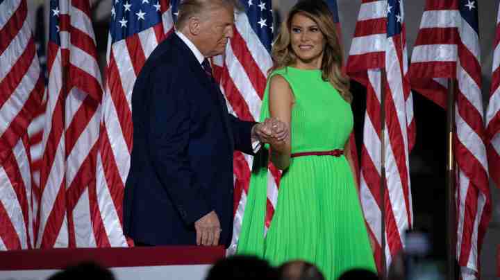 U.S. President Donald Trump leads first lady Melania Trump off the podium as he prepares to deliver his acceptance speech for the Republican presidential nomination on the South Lawn of the White House August 27, 2020 in Washington, DC. Trump gave the speech in front of 1500 invited guests. Photo by Chip Somodevilla/Getty Images