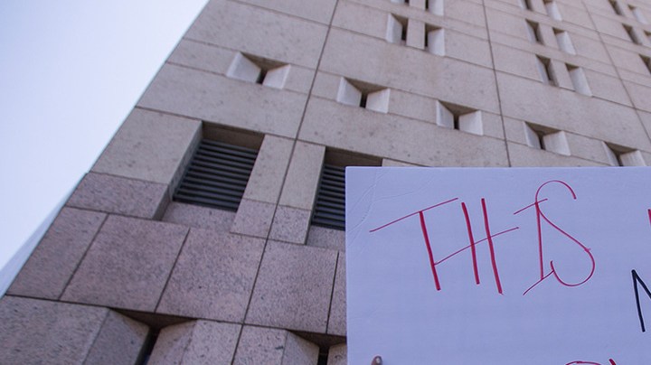People demonstrate and call out words of encouragement to detainees held inside the Metropolitan Detention Center after marching to decry Trump administration immigration and refugee policies on June 30, 2018 in Los Angeles, California. Photo by David McNew/Getty Images.