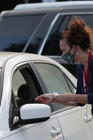 Poll workers at the Miami-Dade County Elections Department deposit peoples' mail in ballots into an official ballot drop box on primary election day on August 18, 2020 in Doral, Florida. Photo by Joe Raedle/Getty Images
