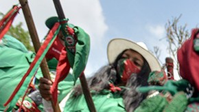 Colombian indigenous taking part in a "Minga" (indigenous meeting) take a rest as they prepare to travel to Bogotá through the Pan-American highway as they demand a meeting with President Iván Duque October 13, 2020 in Cali, Colombia. Photo by Gabriel Aponte/Getty Images