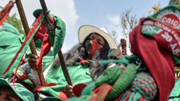 Colombian indigenous taking part in a "Minga" (indigenous meeting) take a rest as they prepare to travel to Bogotá through the Pan-American highway as they demand a meeting with President Iván Duque October 13, 2020 in Cali, Colombia. Photo by Gabriel Aponte/Getty Images