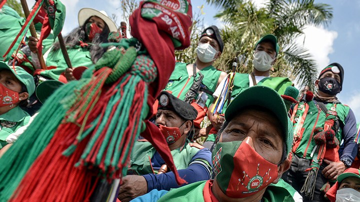 Colombian indigenous taking part in a "Minga" (indigenous meeting) take a rest as they prepare to travel to Bogotá through the Pan-American highway as they demand a meeting with President Iván Duque October 13, 2020 in Cali, Colombia. Photo by Gabriel Aponte/Getty Images