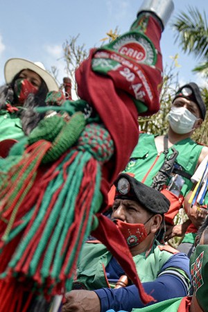 Colombian indigenous taking part in a "Minga" (indigenous meeting) take a rest as they prepare to travel to Bogotá through the Pan-American highway as they demand a meeting with President Iván Duque October 13, 2020 in Cali, Colombia. Photo by Gabriel Aponte/Getty Images