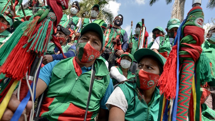 Colombian indigenous taking part in a "Minga" (indigenous meeting) take a rest as they prepare to travel to Bogotá through the Pan-American highway as they demand a meeting with President Iván Duque October 13, 2020 in Cali, Colombia. Photo by Gabriel Aponte/Getty Images