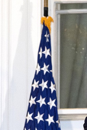 President Donald Trump removes his mask upon return to the White House from Walter Reed National Military Medical Center on October 05, 2020 in Washington, DC. Photo by Win McNamee/Getty Images.