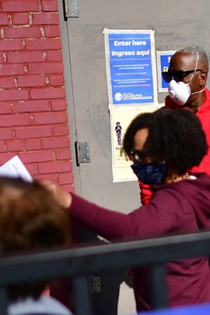 Long lines of voters wait to cast early voting ballots at the A. B. Day School polling location on October 17, 2020 in Philadelphia, Pennsylvania. Photo by Mark Makela/Getty Images