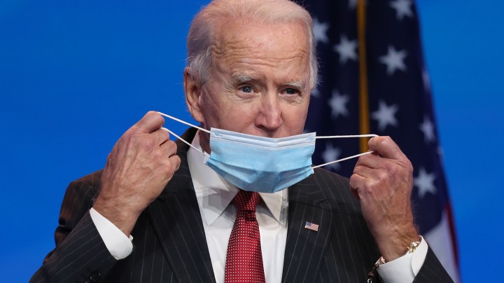 U.S. President-elect Joe Biden removes his protective mask as he addresses the media after a virtual meeting with the National Governors Association's executive committee at the Queen Theater on November 19, 2020 in Wilmington, Delaware. Photo by Joe Raedle/Getty Images