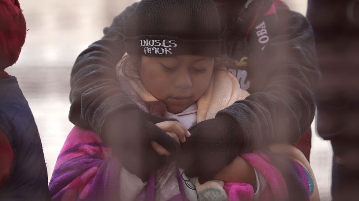 Central American immigrants wait to be taken into custody at the U.S.-Mexico border fence after crossing the Rio Grande from Mexico on February 01, 2019 in El Paso, Texas. Photo by John Moore/Getty Images