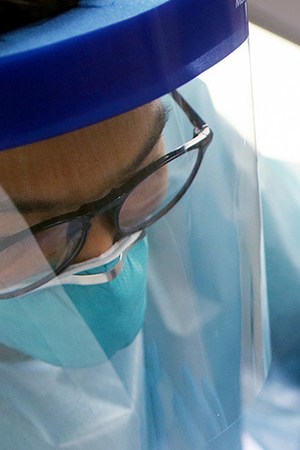 A nurse applies a band- aid after administering the flu vaccination shot to a woman at a free clinic held at a local library on October 14, 2020 in Lakewood, California. Photo by Mario Tama/Getty Images.