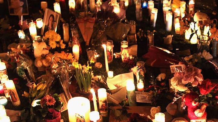 U.S. born children of Mexican immigrants gaze at a makeshift shrine at the University Medical Center, for those killed and wounded during an attack on U.S. Rep. Gabrielle Giffords (D-AZ) on January 9, 2011 in Tucson, Arizona. Photo by John Moore/Getty Images