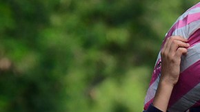 A young boy walks with a bag on his back on the streets flooded by the Tropical Storm Eta on November 8, 2020 in Rio Nance, Honduras. Photo by Yoseph Amaya/Getty Images