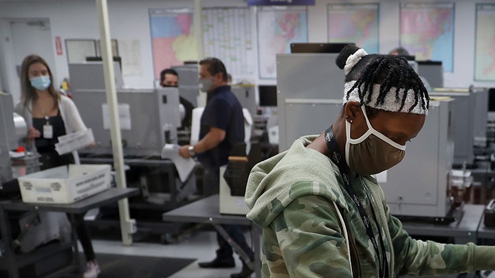 Workers at the Miami-Dade County Elections Department work on tabulating the Vote by Mail ballots that have been returned for the general election on October 30, 2020 in Doral, Florida. Photo by Joe Raedle/Getty Images