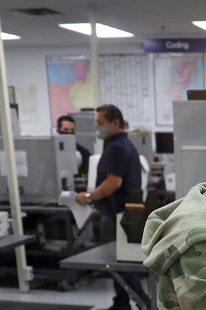 Workers at the Miami-Dade County Elections Department work on tabulating the Vote by Mail ballots that have been returned for the general election on October 30, 2020 in Doral, Florida. Photo by Joe Raedle/Getty Images