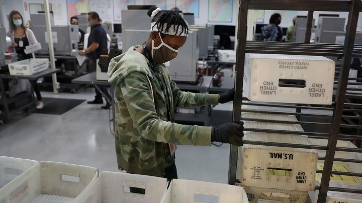 Workers at the Miami-Dade County Elections Department work on tabulating the Vote by Mail ballots that have been returned for the general election on October 30, 2020 in Doral, Florida. Photo by Joe Raedle/Getty Images