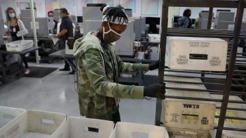 Workers at the Miami-Dade County Elections Department work on tabulating the Vote by Mail ballots that have been returned for the general election on October 30, 2020 in Doral, Florida. Photo by Joe Raedle/Getty Images