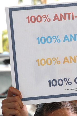 Wearing a face masks to reduce the risk posed by the coronavirus, Sophia Hildalgo (L) and Amore Rodriguez of Miami stay with their car decorated in Cubans for Biden paint as Democratic presidential nominee Joe Biden delivers remarks during a drive-in voter mobilization event at Miramar Regional Park October 13, 2020 in Miramar, Florida. Photo by Chip Somodevilla/Getty Images
