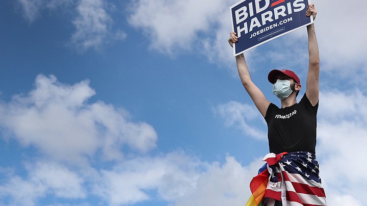 Marco Incer stands on the roof of his car as he shows support for Democratic presidential nominee Joe Biden during a Worker Caravan for Biden event on October 18, 2020 in Doral, Florida. Photo by Joe Raedle/Getty Images