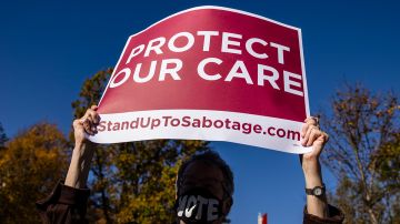 A supporter of the Affordable Care Act (ACA) stands in front of the Supreme Court of the United States as the Court begins hearing arguments from California v. Texas about the legality of the ACA on November 10, 2020 in Washington, DC. Photo by Samuel Corum/Getty Images