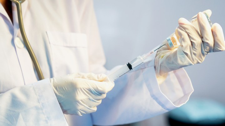 Close-Up Of Doctor Filling Medical Injection. Getty Images