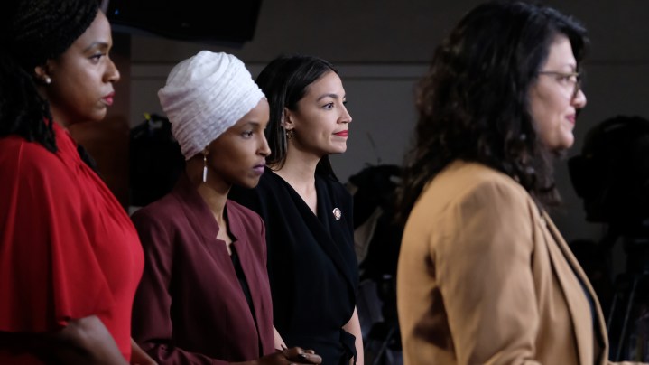U.S. Reps. Ayanna Pressley (D-MA), Ilhan Omar (D-MN) and Alexandria Ocasio-Cortez (D-NY) listen as Rep. Rashida Tlaib (D-MI) pauses while speaking at a news conference at the U.S. Capitol on July 15, 2019 in Washington, D.C. Photo by Alex Wroblewski/Getty Images