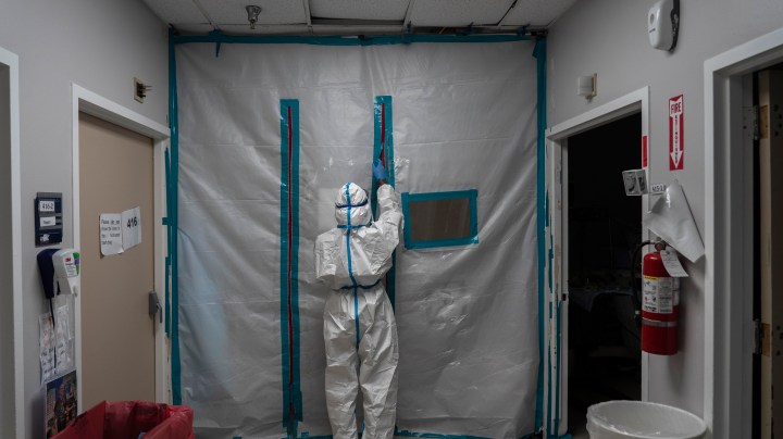 A medical staff exits the COVID-19 intensive care unit (ICU) on New Year's Day at the United Memorial Medical Center on January 1, 2021 in Houston, Texas. Photo by Go Nakamura/Getty Images