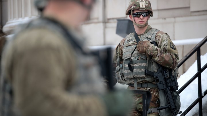 National guard troops stand guard near of the Kenosha County Courthouse as they wait for an announcement from the Kenosha district attorney on whether charges would be filed against Officer Rusten Sheskey on January 05, 2021 in Kenosha, Wisconsin. Photo by Scott Olson/Getty Images