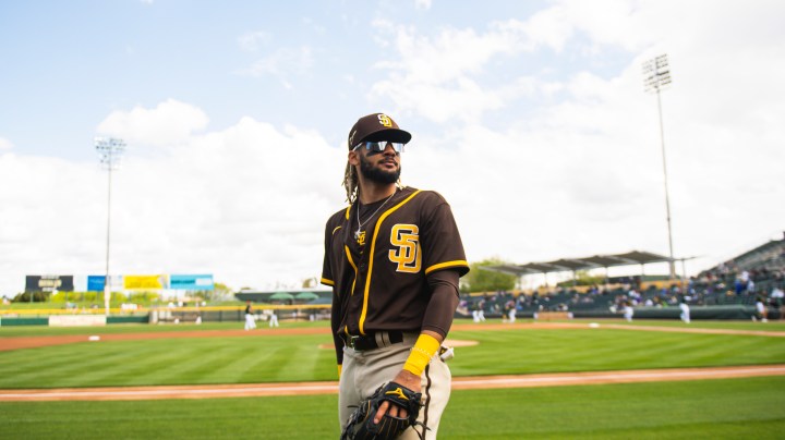 Infielder Fernando Tatis Jr. #23 of the San Diego Padres looks to toss a ball to a fan before facing the Oakland Athletics at HoHoKam Stadium on March 12, 2021 in Mesa, Arizona. (Photo by Matt Thomas/San Diego Padres/Getty Images)