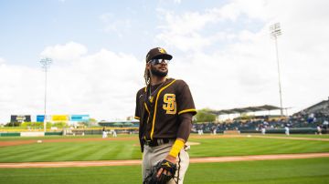 Infielder Fernando Tatis Jr. #23 of the San Diego Padres looks to toss a ball to a fan before facing the Oakland Athletics at HoHoKam Stadium on March 12, 2021 in Mesa, Arizona. (Photo by Matt Thomas/San Diego Padres/Getty Images)