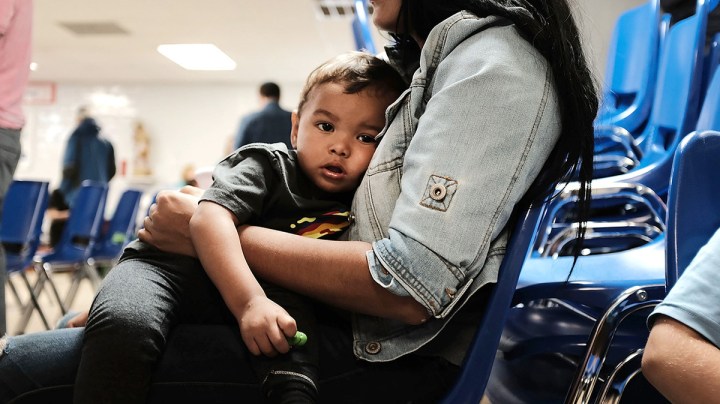A woman who idendtified herself as Jennifer sits with her son Jaydan at the Catholic Charities Humanitarian Respite Center after recently crossing the U.S., Mexico border on June 21, 2018 in McAllen, Texas. (Photo by Spencer Platt/Getty Images)