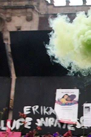 A woman, takes part during a performance of Feminist groups, to write names of victims of femicide and place flowers in protest against gender violence, as part of the protests of International Women's Day at the National Palace on March 7, 2021 in Mexico City, Mexico. Photo credit Luis Barron / Eyepix Group/Barcroft Media via Getty Images
