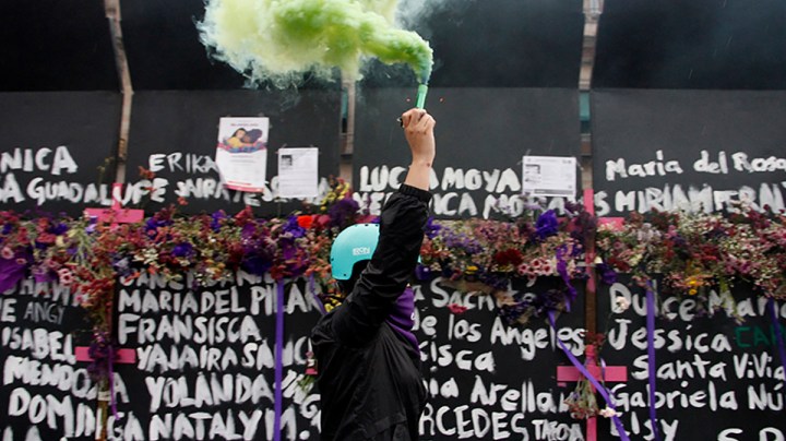 A woman, takes part during a performance of Feminist groups, to write names of victims of femicide and place flowers in protest against gender violence, as part of the protests of International Women's Day at the National Palace on March 7, 2021 in Mexico City, Mexico. Photo credit Luis Barron / Eyepix Group/Barcroft Media via Getty Images