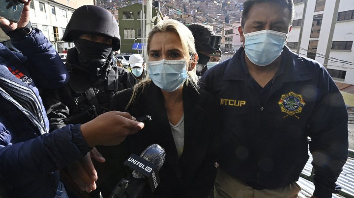 Former interim Bolivia's President Jeannine Anez (C) is escorted by police members of the Special Force against Crime (FELCC) after being arrested in La Paz, on March 13, 2021. Photo by AIZAR RALDES/AFP via Getty Images
