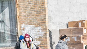 A mother and 2 kids received coats and toys during New York Cares volunteers in partnership with Together We Can local non-profit organization and Assemblywoman Catalina Cruz distribution of holidays toys and winter coats in Corona, Queens. Photo by Lev Radin/Pacific Press/LightRocket via Getty Images