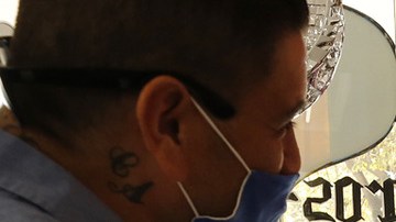 Janie Isidoro, owner of My Corazon, a Chicano business in downtown Hanford, CA helps Carlos Garcia, left. Al Seib / Los Angeles Times