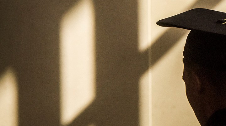 A graduate paces in the sun streaked lobby of the Civic Building before the Montgomery branch of the Latin American Youth Center (LAYC), the DC non-profit, holds its graduation ceremony for its GED students, on May, 25, 2016 in Silver Spring, MD. Photo by Bill O'Leary/The Washington Post via Getty Images.
