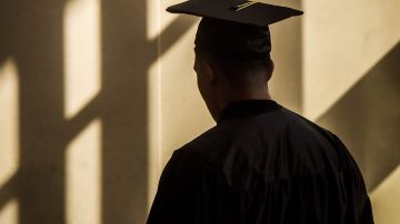 A graduate paces in the sun streaked lobby of the Civic Building before the Montgomery branch of the Latin American Youth Center (LAYC), the DC non-profit, holds its graduation ceremony for its GED students, on May, 25, 2016 in Silver Spring, MD. Photo by Bill O'Leary/The Washington Post via Getty Images.