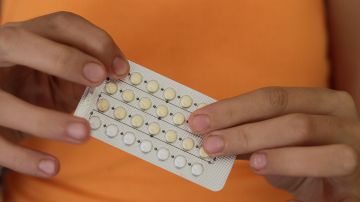 Woman's hands holding birth control pills. Photo Courtesy of Getty Images