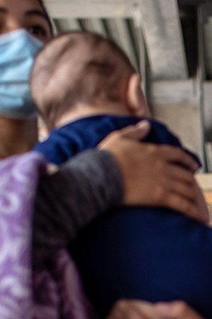 Central American asylum seekers arrive to a bus station after being released by U.S. Border Patrol agents on February 26, 2021 in Brownsville, Texas. U.S. immigration authorities are now releasing many asylum seeking families after they cross the U.S.-Mexico border and are taken into custody. Photo by John Moore/Getty Images