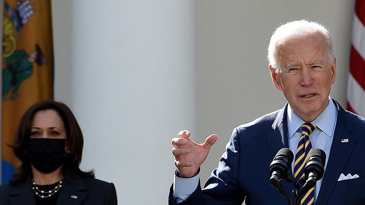 US President Joe Biden, with Vice President Kamala Harris (L) and Senate Majority Leader Chuck Schumer, Democrat of New York, speaks about the American Rescue Plan in the Rose Garden of the White House in Washington, DC, on March 12, 2021. Photo by OLIVIER DOULIERY/AFP via Getty Images