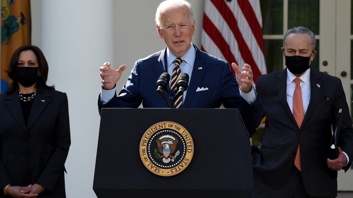 US President Joe Biden, with Vice President Kamala Harris (L) and Senate Majority Leader Chuck Schumer, Democrat of New York, speaks about the American Rescue Plan in the Rose Garden of the White House in Washington, DC, on March 12, 2021. Photo by OLIVIER DOULIERY/AFP via Getty Images