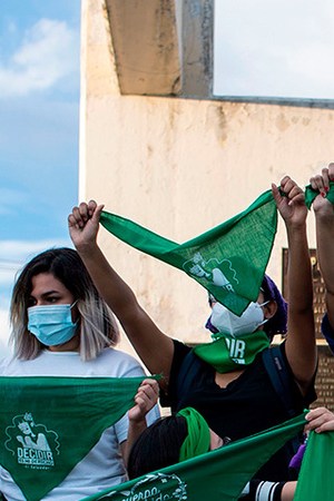 Activists raise green headscarves during a demonstration demanding the legalisation of abortion at the Constitution Square in the framework of the International Safe Abortion Day in San Salvador, on September 28, 2020. Photo by YURI CORTEZ/AFP via Getty Images