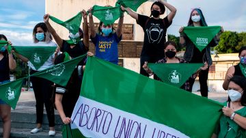 Activists raise green headscarves during a demonstration demanding the legalisation of abortion at the Constitution Square in the framework of the International Safe Abortion Day in San Salvador, on September 28, 2020. Photo by YURI CORTEZ/AFP via Getty Images