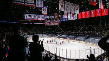 New York Islanders and the Philadelphia Flyers stand during the National Anthem at Nassau Coliseum on March 18, 2021 in Uniondale, New York. Philadelphia Flyers defeated the New York Islanders 4-3. Photo by Mike Stobe/NHLI via Getty Images