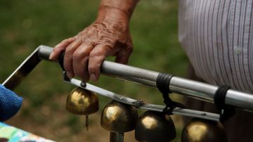 Mauro Rios Parra rings the bell of his ice cream cart during his route in Pico Union on Tuesday, June 16, 2020 in Los Angeles, CA. Parras bell is an essential tool to sell to clients. Dania Maxwell / Los Angeles Times via Getty Images