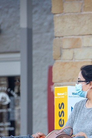Customers leave Walmart on March 3, 2021 in Austin, Texas. Gov. Greg Abbott announced today that the state will end its mask mandate and allow businesses to reopen at 100 percent capacity on March 10. Photo by Montinique Monroe/Getty Images