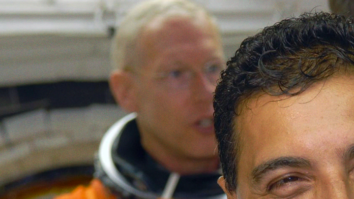 In the White Room on NASA Kennedy Space Center's Launch Pad 39A, STS-128 Mission Specialist Jose Hernandez waits his turn to enter space shuttle Discovery. In the background are Mission Specialists Patrick Forrester (left) and Christer Fuglesang (back to camera). Photo credit: NASA/Jim Grossmann